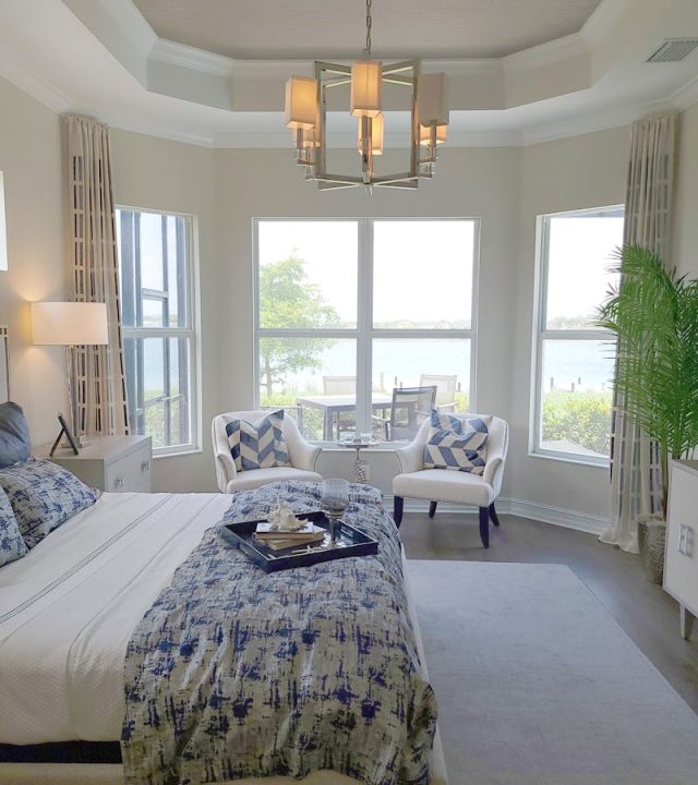 Bright and airy bedroom featuring elegant decor with coastal views, a perfect show home setup.